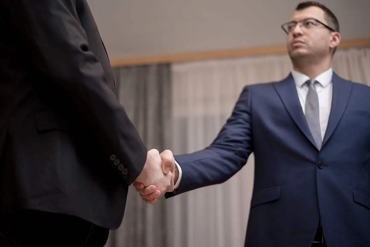 A handshake closing a cash home sale in Iowa