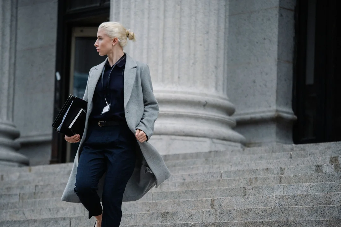 A foreclosure attorney with case folders outside an Iowa courthouse