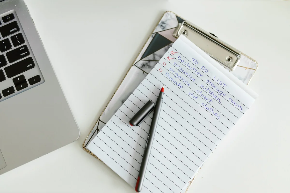 A checklist and pen on a desk, the paperwork to sell a house for cash in Iowa