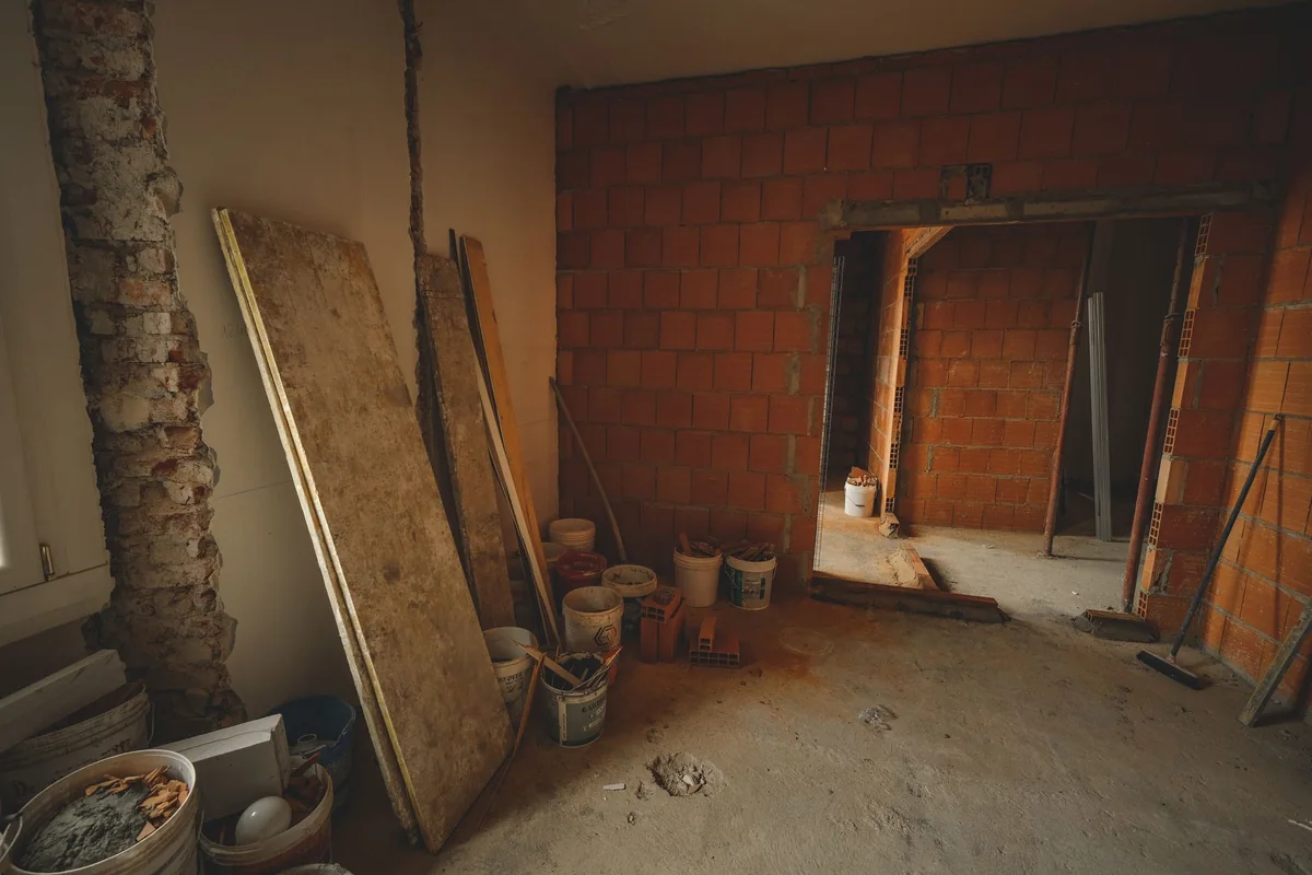 A house mid-renovation with construction tools and materials, the repair budget subtracted when cash home buyers calculate their offer