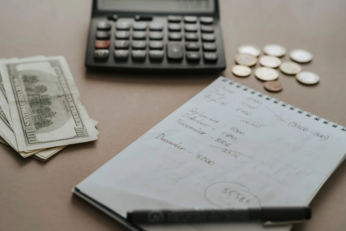 A notebook and calculator used to figure a house buyout in an Iowa divorce