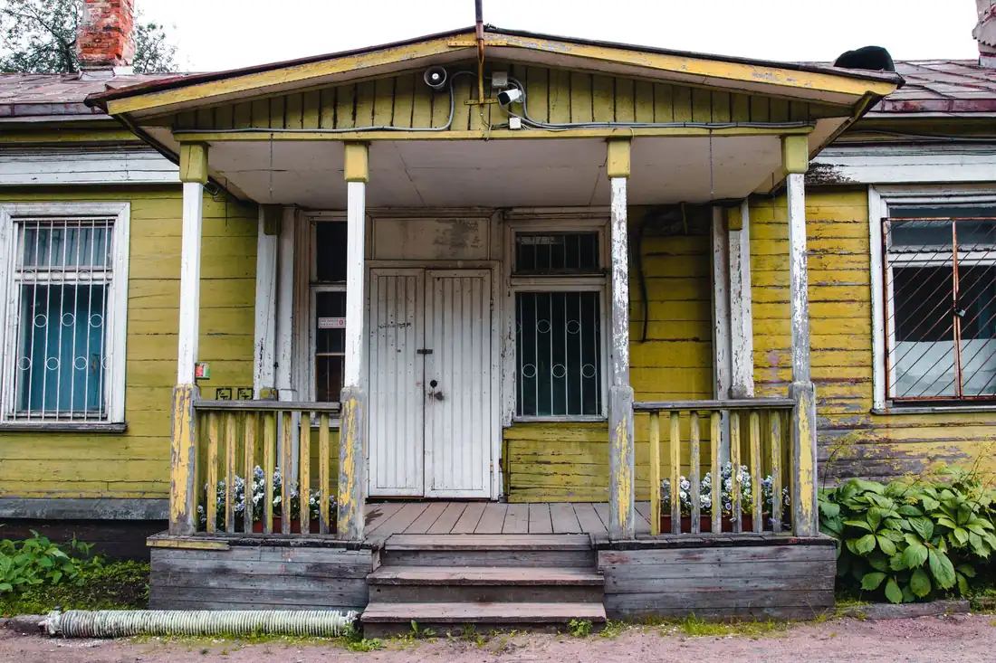 A worn older Iowa house that needs work, the kind of property behind the selling as-is vs fixing it up decision