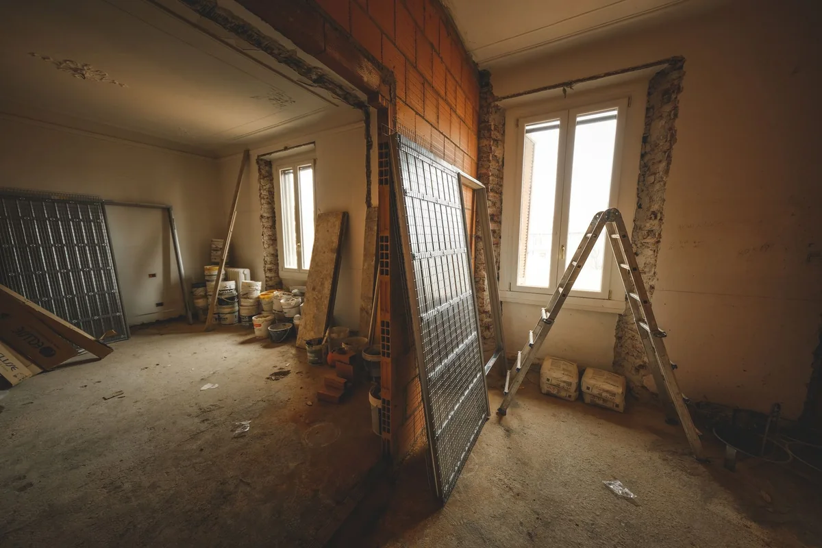 A gutted home interior mid-renovation, showing the time, tools, and cost of fixing up a house before selling