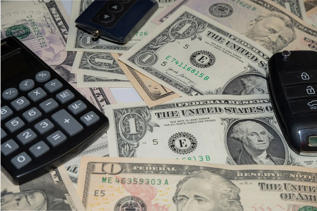 A calculator and cash on a table, the honest math behind a cash offer on a condemned house