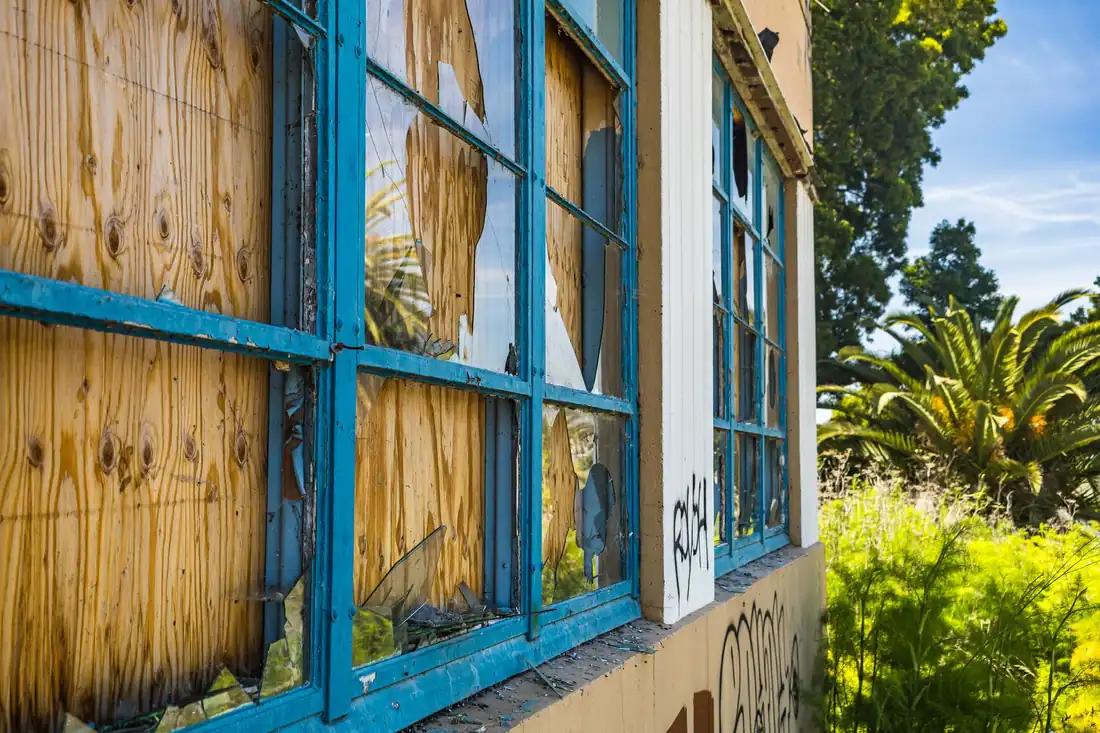 A boarded-up house with broken windows, the kind of condemned property owners in Iowa look to sell