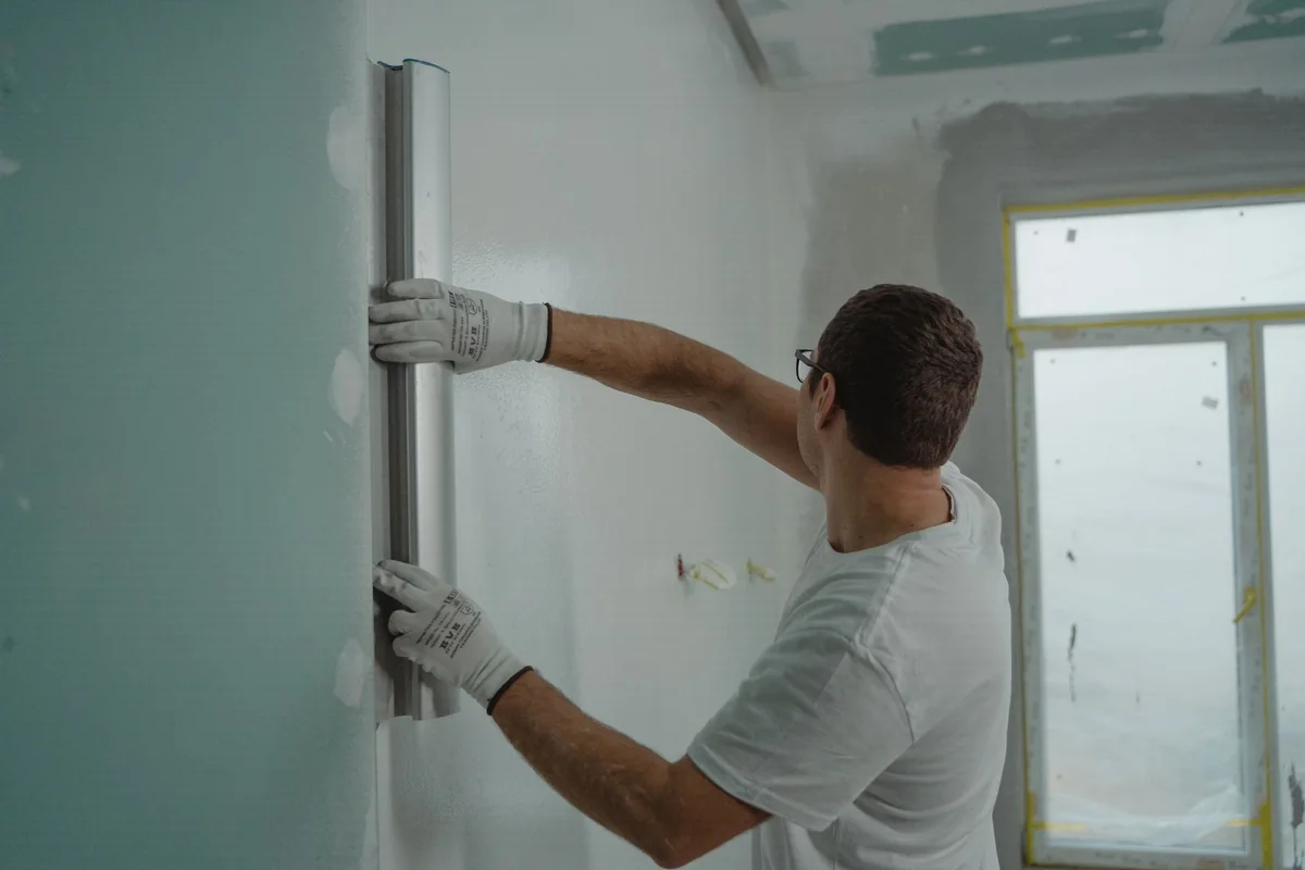 A contractor painting a room during a fire damage restoration