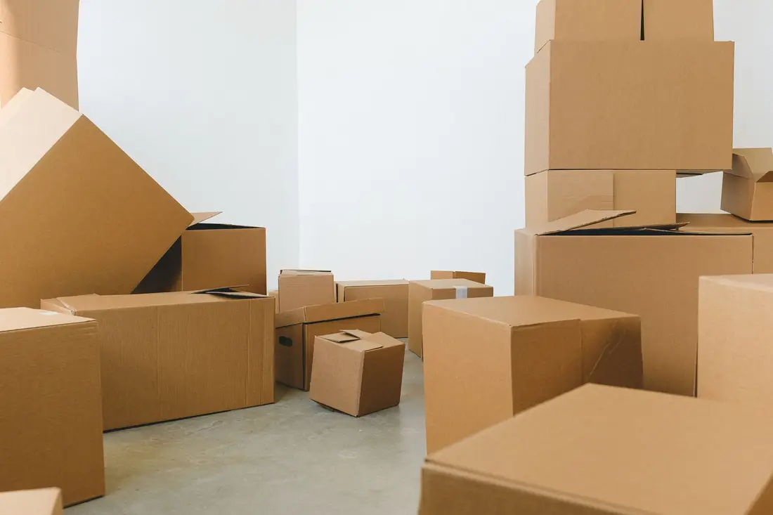 Boxes filling a room, the everyday reality behind how to sell a hoarder house in Iowa