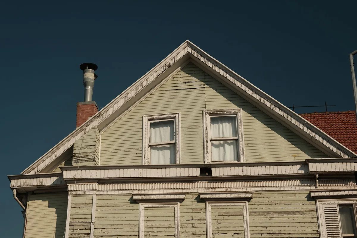 An older Iowa house with visible wear that a seller must still disclose when selling as-is