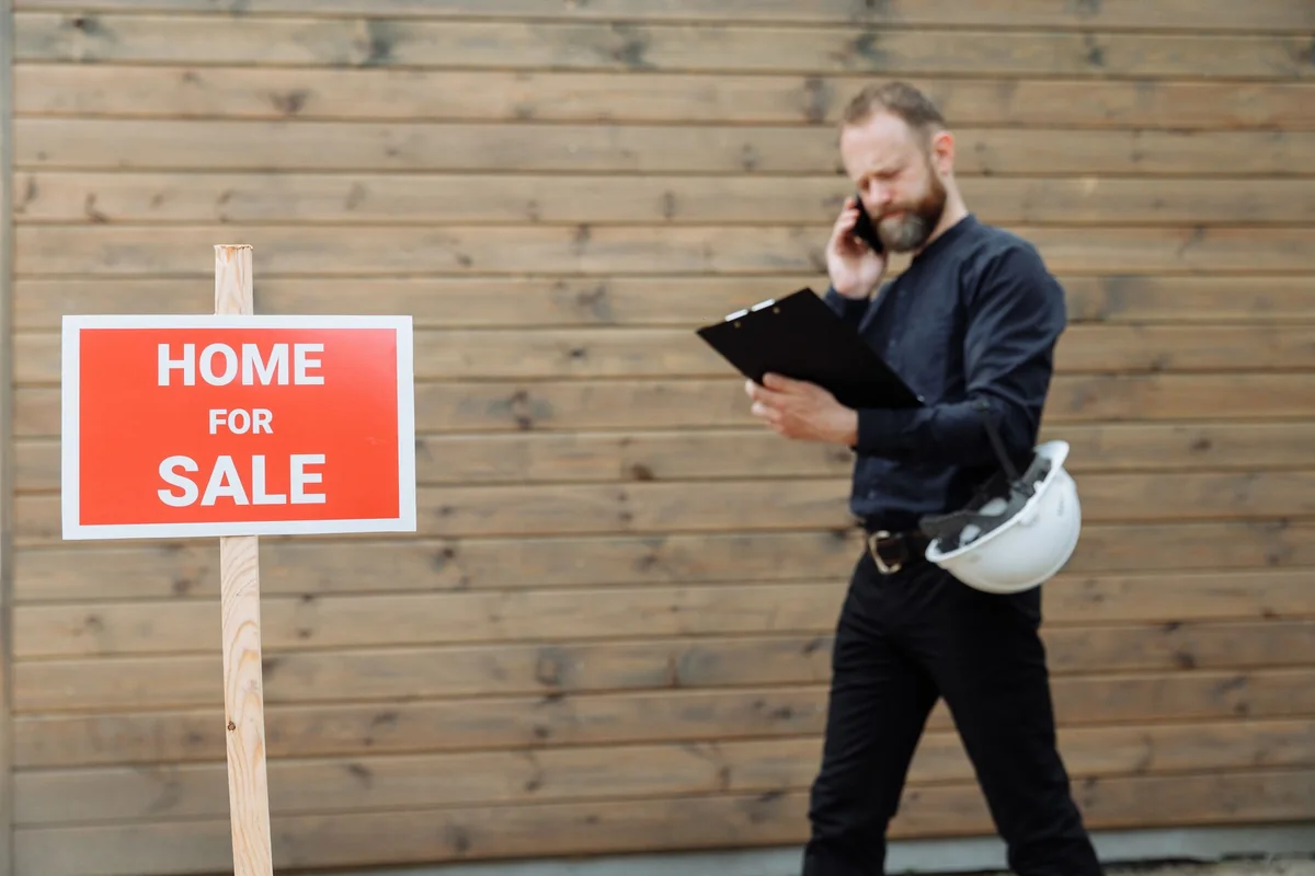 A real estate professional reviewing a home's condition before an as-is sale