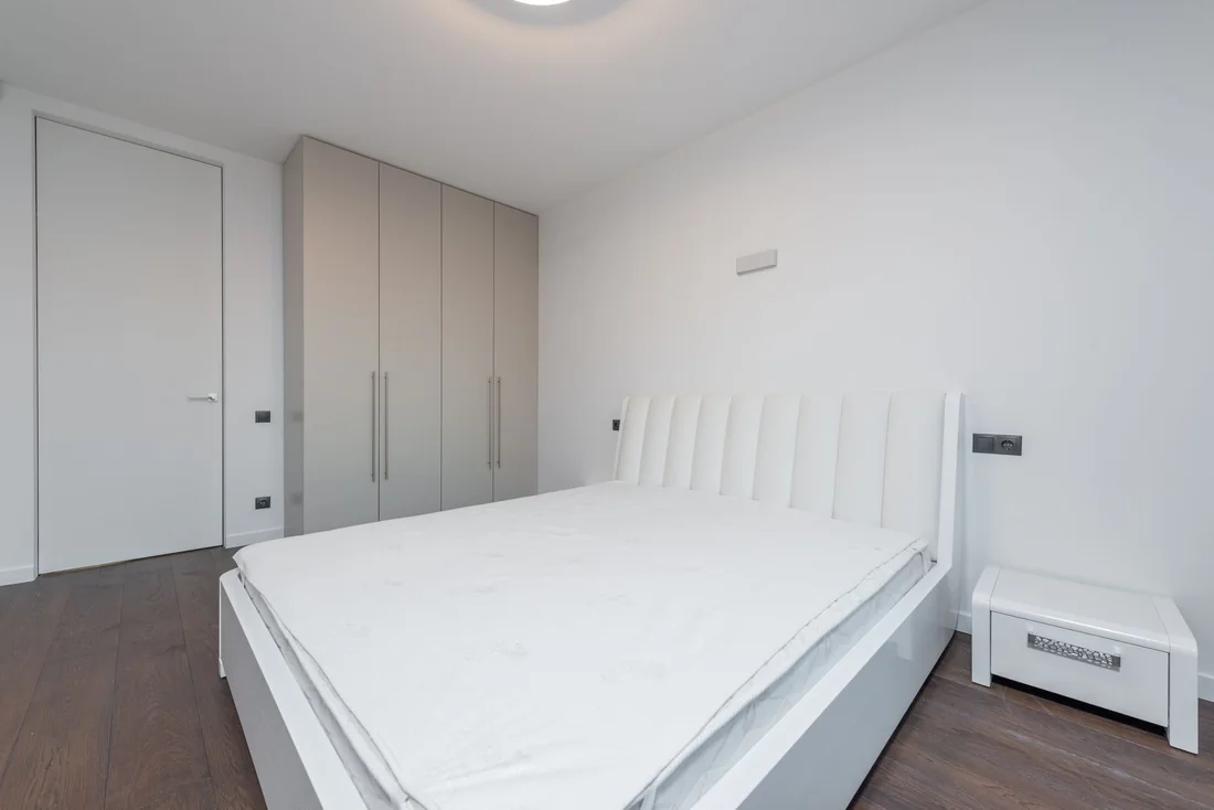 A clean, tidy bedroom with bare floors, the look a buyer wants when you are selling a house with a bug infestation in Iowa