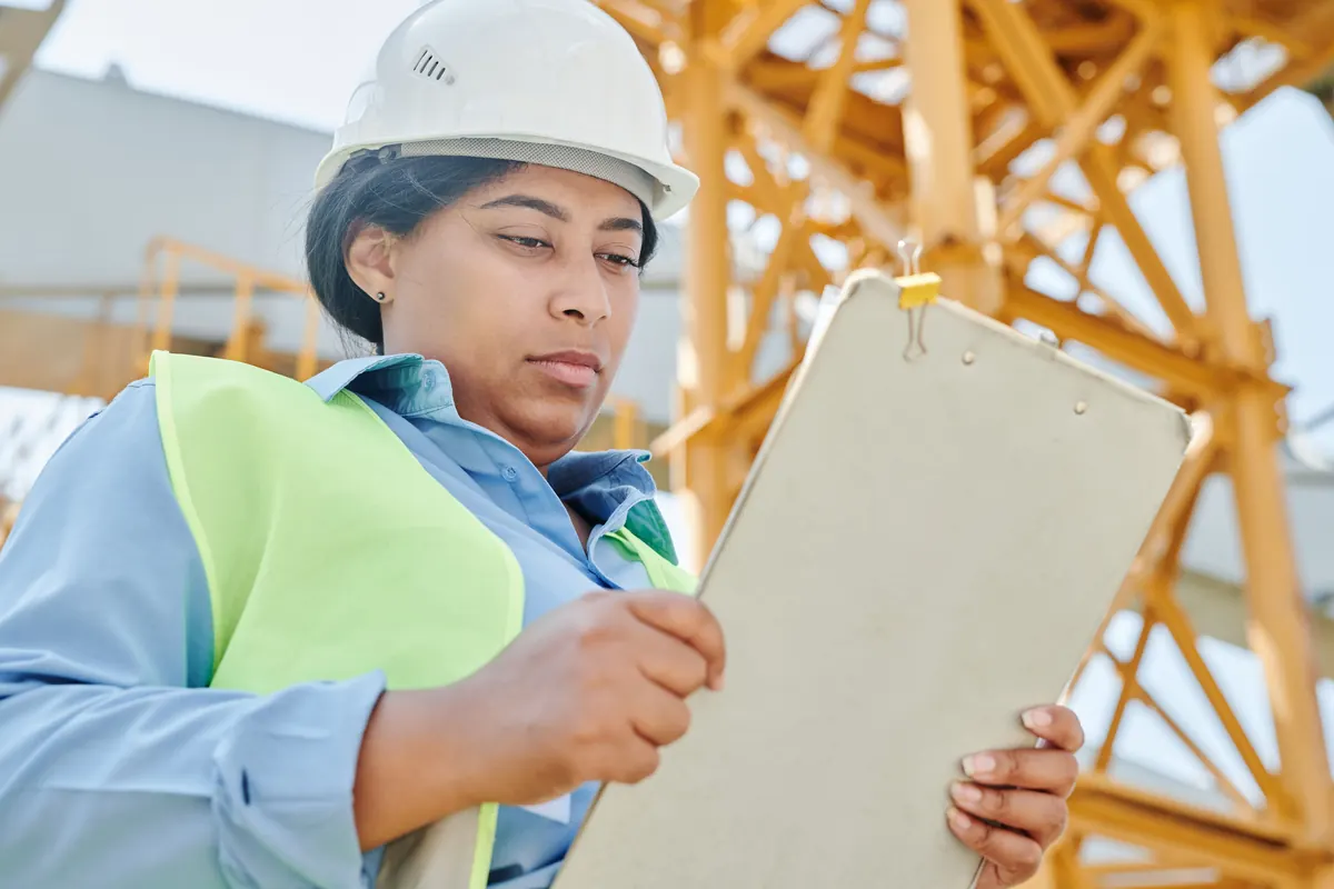 An inspector with a clipboard, checking a house before a sale