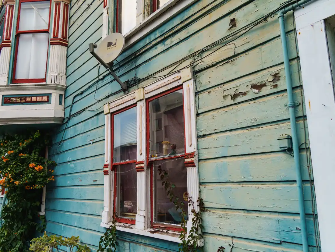 An older Iowa house with aged paint, the kind of home that can carry code violations