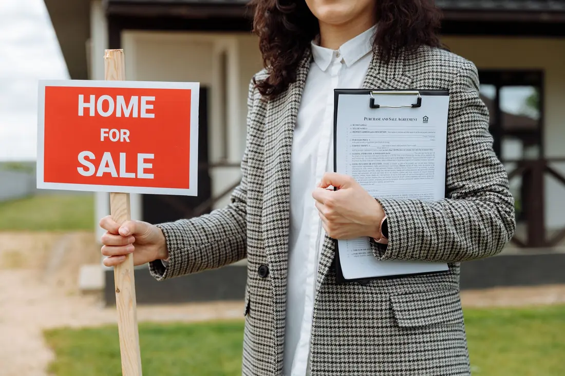 A for-sale sign held outside an Iowa home after selling a house that failed appraisal
