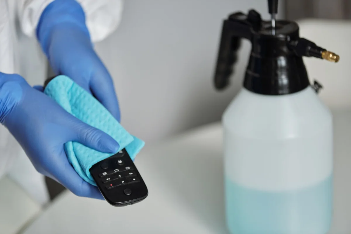 A gloved hand wiping a surface, similar to a certified meth surface-wipe test on a house