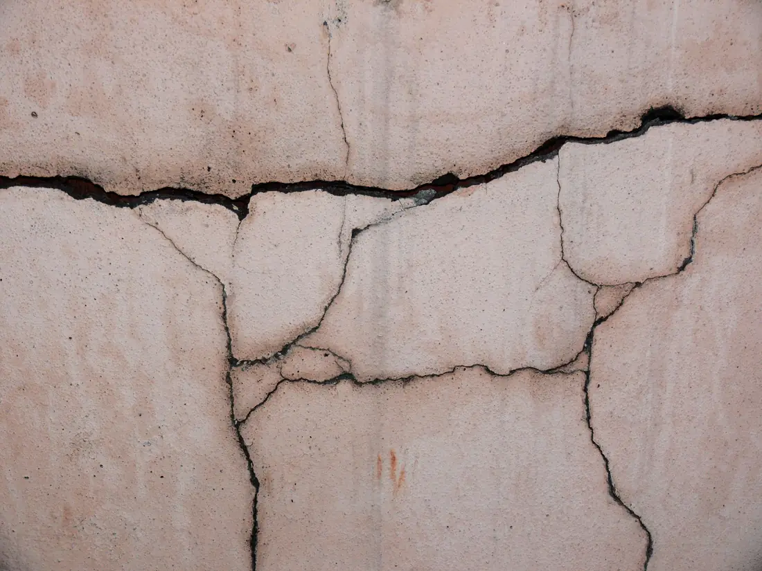 A cracked concrete foundation wall on a house being sold in Iowa