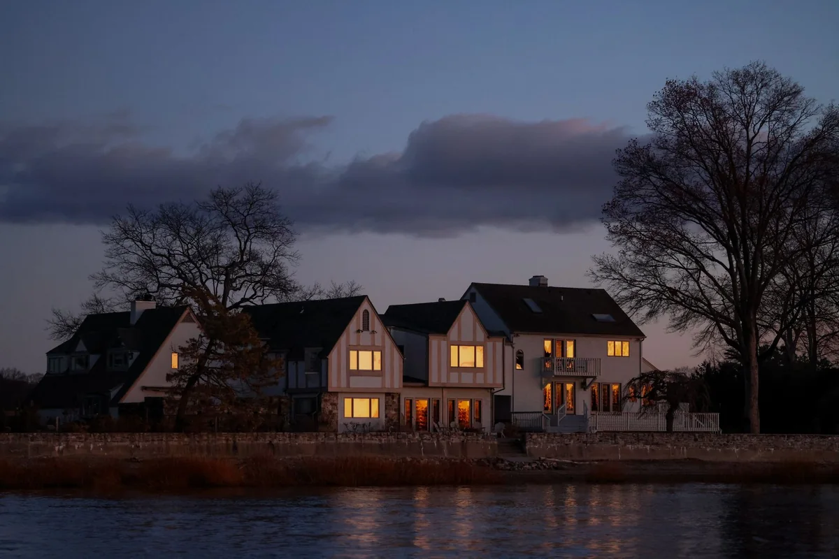 Houses along a river, illustrating the options for selling a house in a flood zone in Iowa