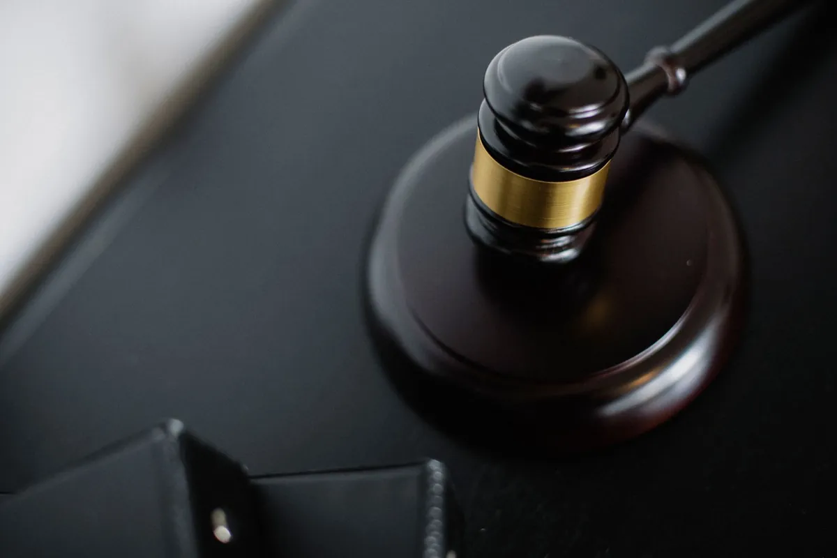 A wooden gavel on a desk, representing Iowa's Chapter 656 forfeiture process for a contract for deed