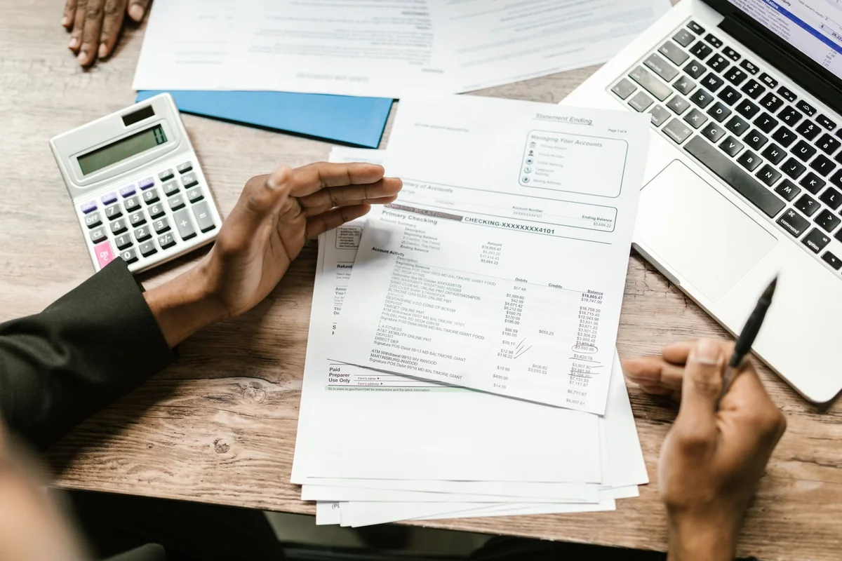 Mortgage statement and calculator on a desk, used to figure out if you owe more than the house is worth