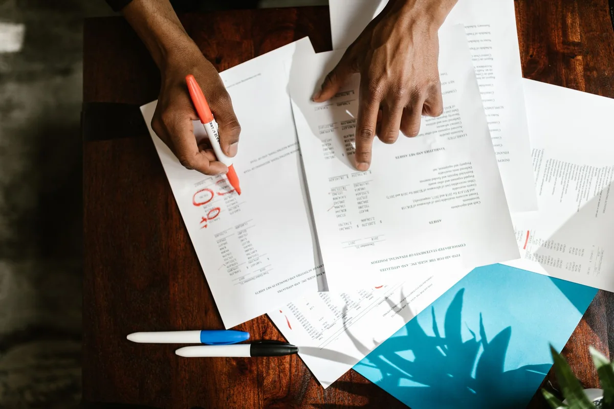 A homeowner at a kitchen table weighing how to sell a house that needs repairs