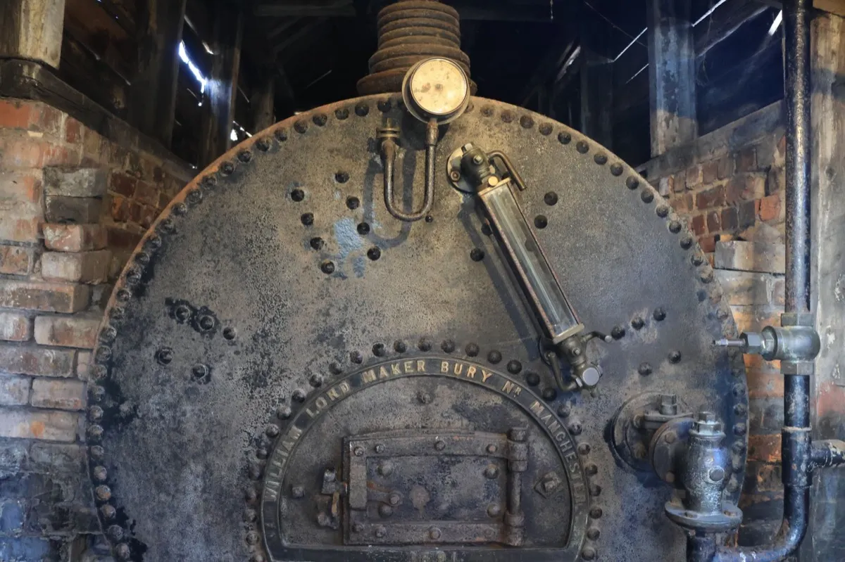 An old basement heating system, the kind of furnace an underground oil tank once fed before a house switched to gas