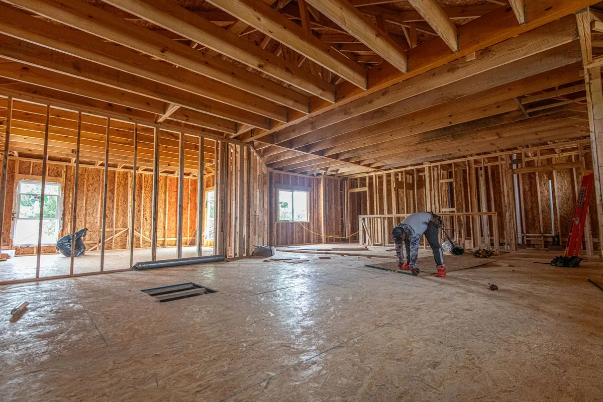 Interior framing and unfinished drywall in a home mid-renovation