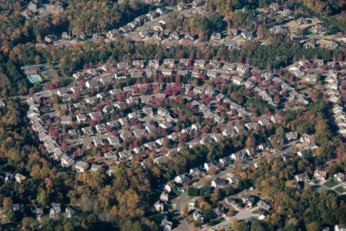 Aerial view of a planned suburban subdivision, the kind of HOA community where unpaid dues can lead to collection or foreclosure