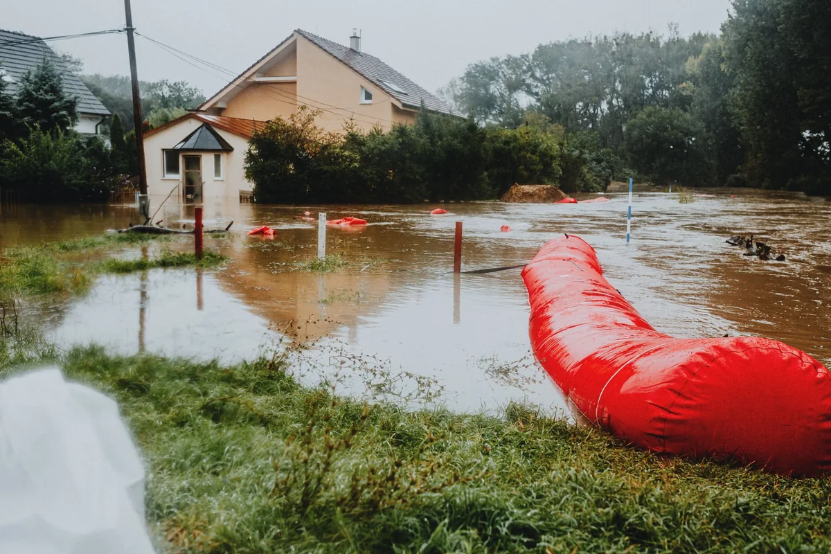 A flooded yard next to a house, the kind of water history an Iowa seller must disclose
