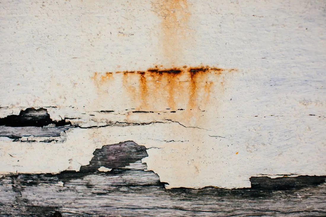 A rusty water stain and peeling paint, the visible sign of water damage on a house for sale in Iowa