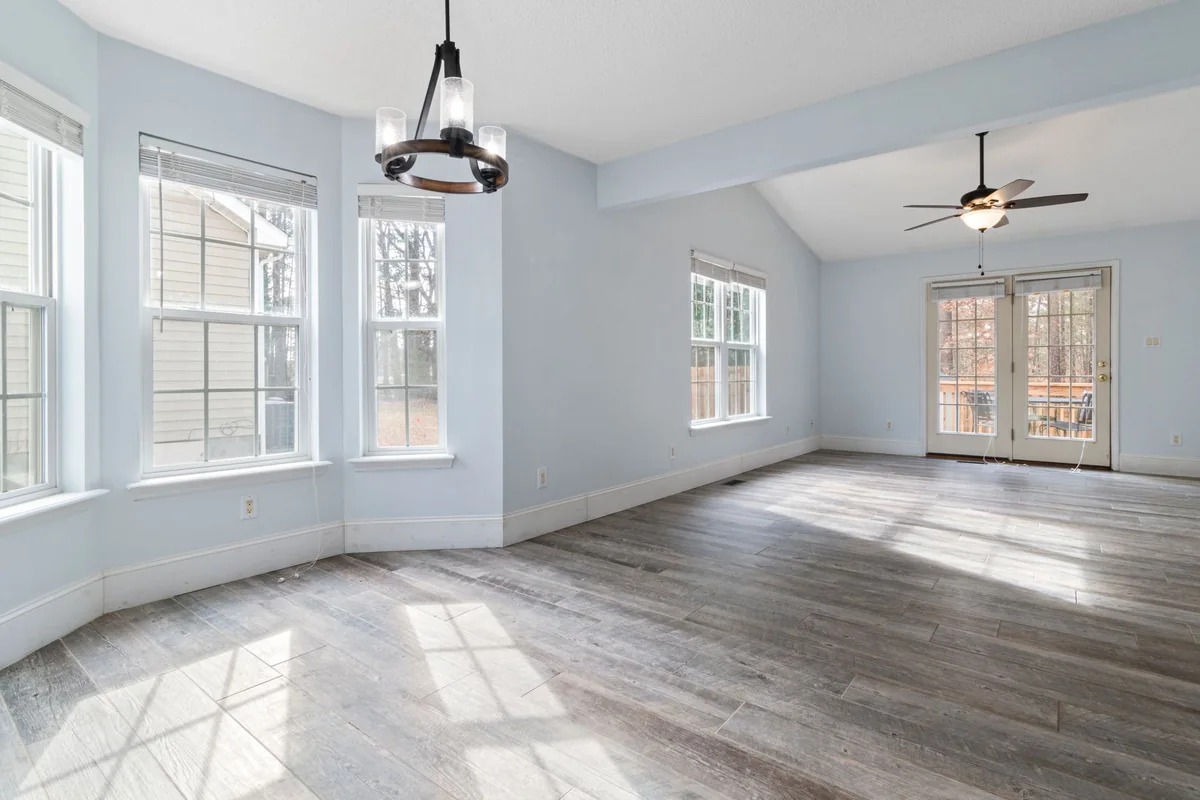 A quiet, empty sunlit room in a home where a peaceful death occurred