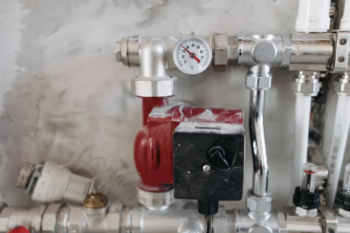 An aging home heating system with a temperature gauge, the kind an inspector red-tags