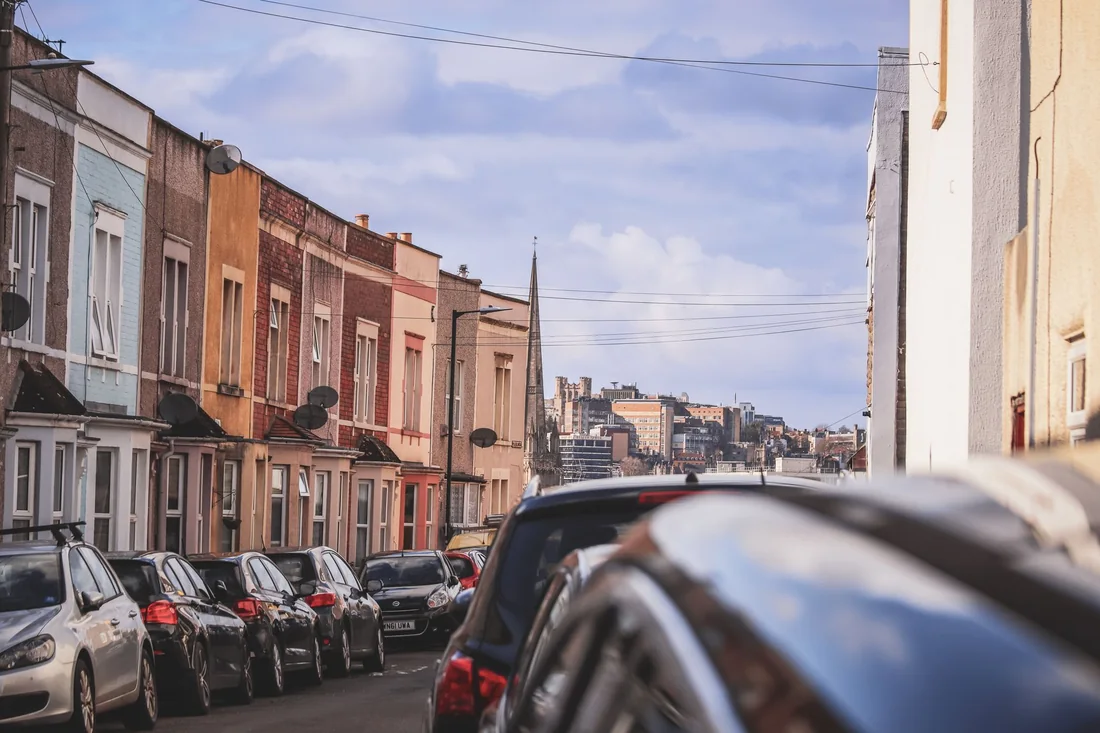 A street of houses packed tightly together, the kind of close quarters that make selling a house with bad neighbors in Iowa harder