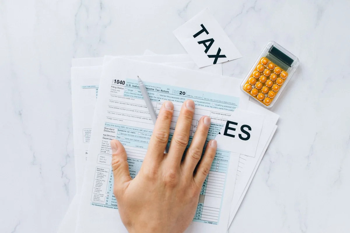 Person filling out IRS Form 14135 to request a certificate of discharge of a federal tax lien