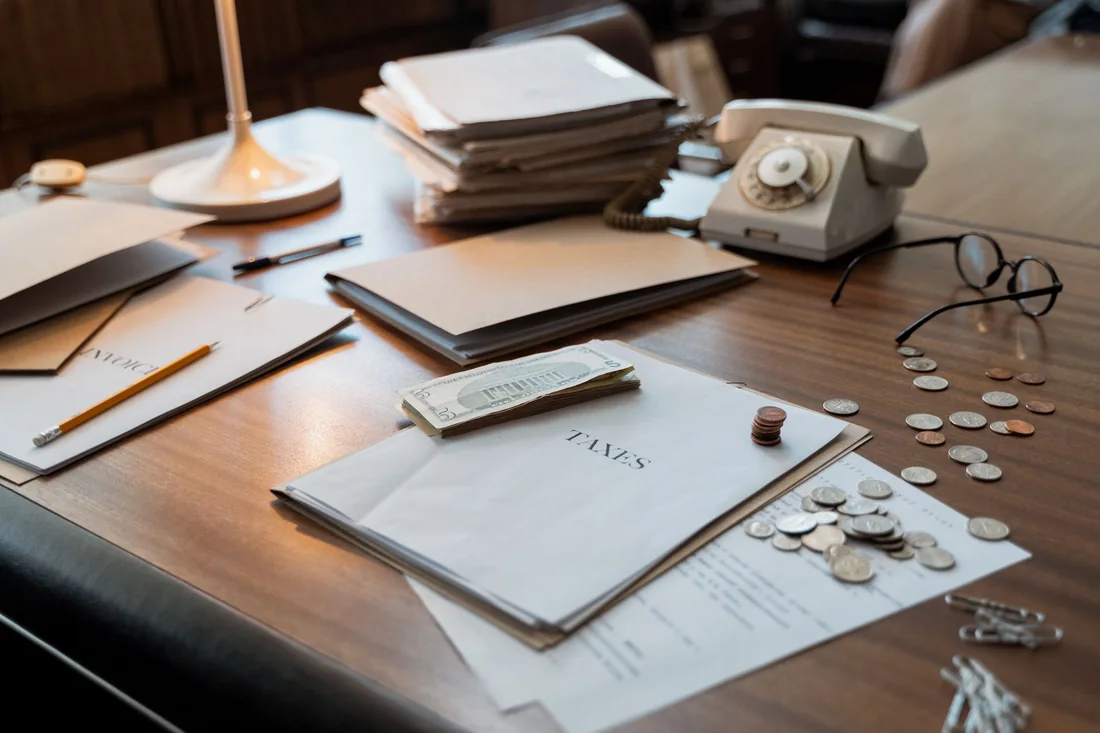 A homeowner reviewing tax paperwork and house keys before selling a house with an IRS tax lien in Iowa