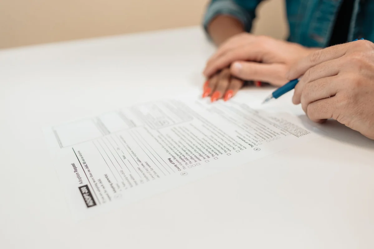 A seller signing the federal lead-based paint disclosure before selling a house