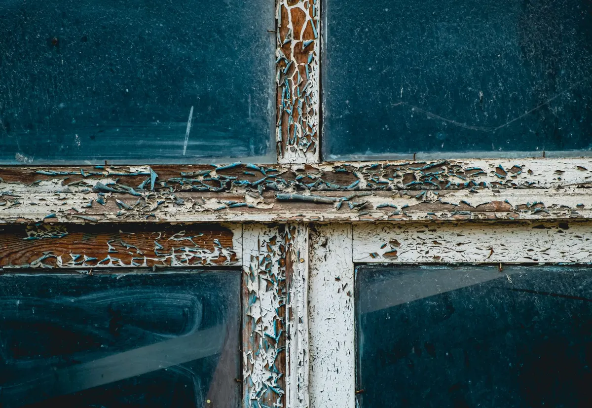 Peeling lead paint on an old window frame that does not need to be fixed to sell
