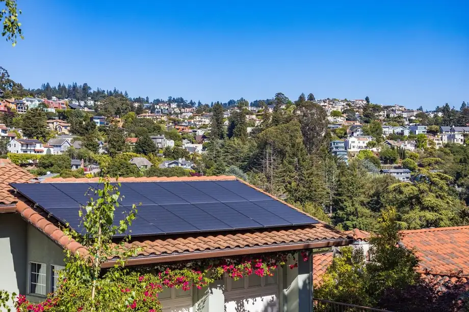 Solar panels on the roof of a suburban house, the setup you deal with when selling a house with leased solar panels in Iowa