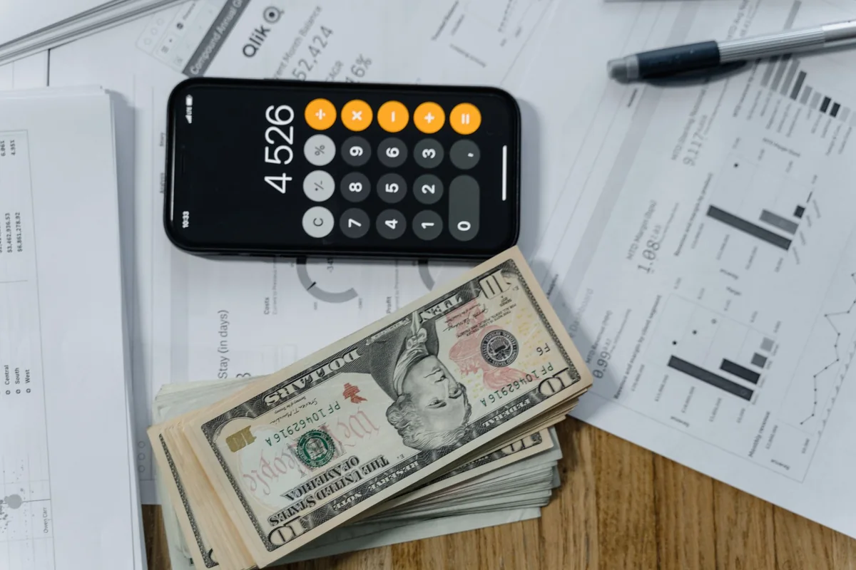 A calculator, cash, and documents showing how to handle a lien bigger than your equity