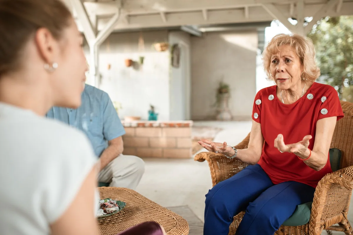 An elderly mother and her adult daughter talking on a porch, the life tenant and remainderman of a life estate