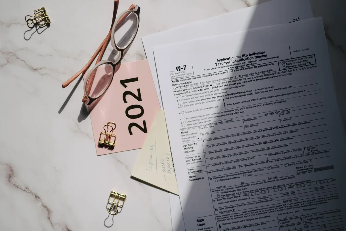 Reading glasses on a government form, representing a Medicaid estate recovery notice on an inherited house