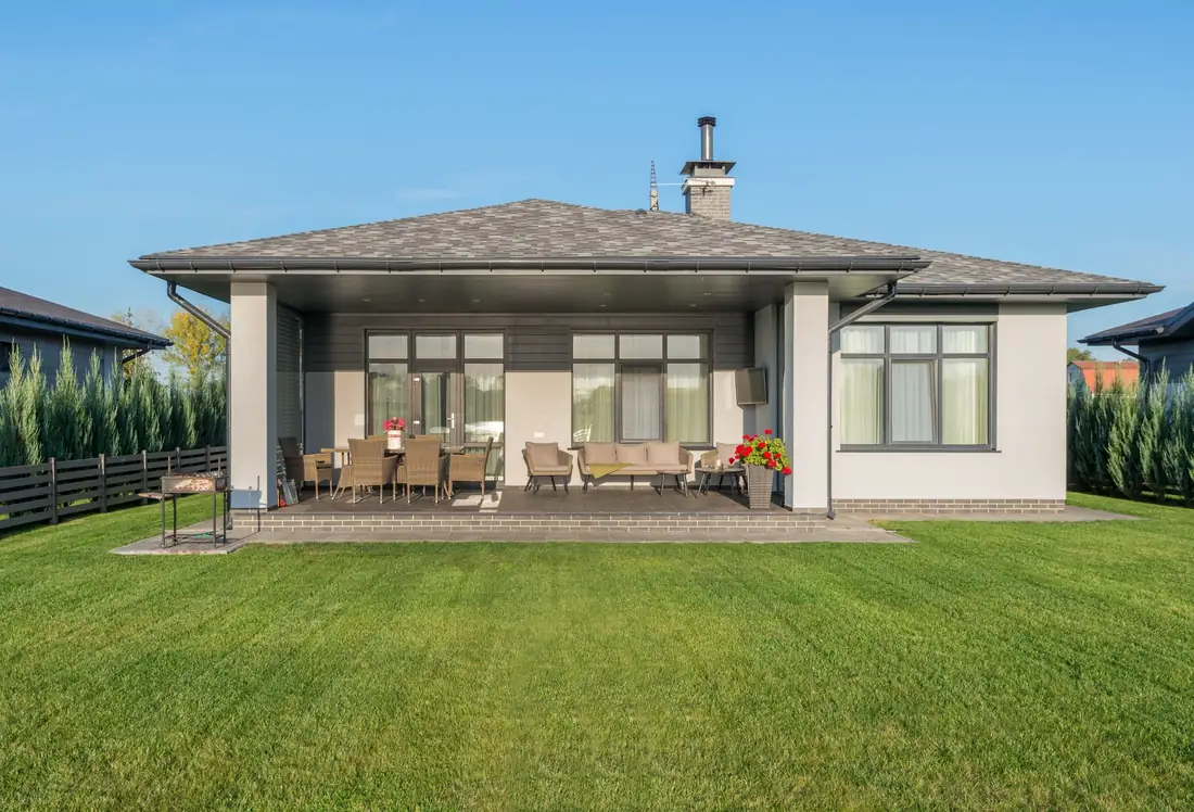 An Iowa family home behind a green lawn, the kind of inherited house affected by a Medicaid lien and estate recovery