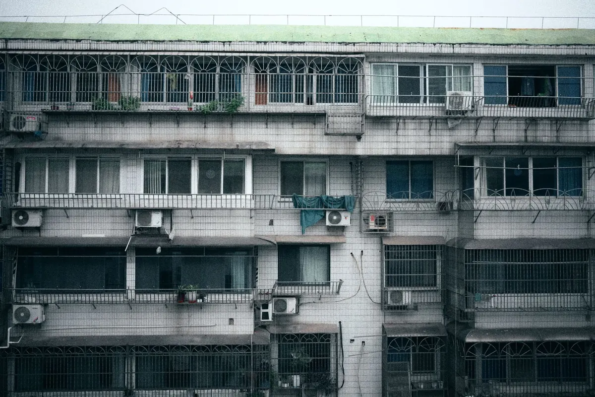Window air conditioning units on an apartment building, a common stand-in when a house has no central air