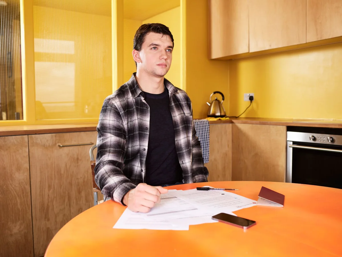 A homeowner at a table weighing how to sell a house with old wiring in Iowa