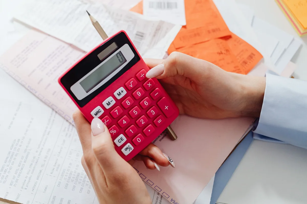A calculator and paperwork used to weigh reverse mortgage payoff options as an heir