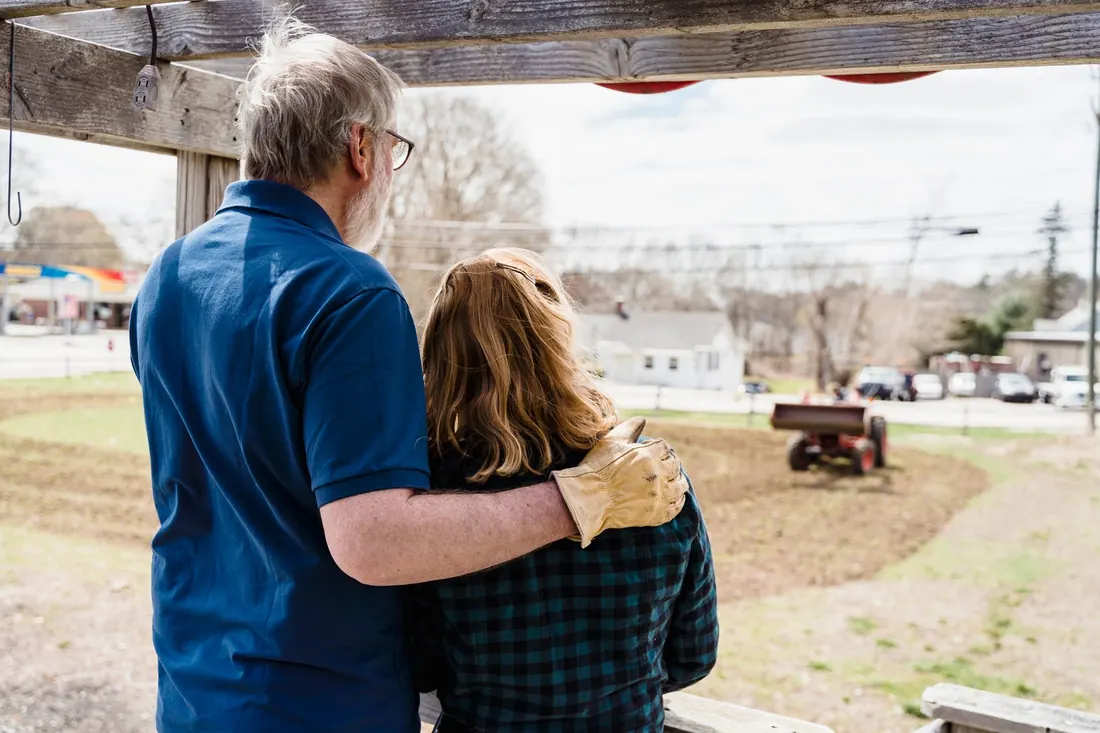 An older couple standing outside a house with a reverse mortgage in Iowa