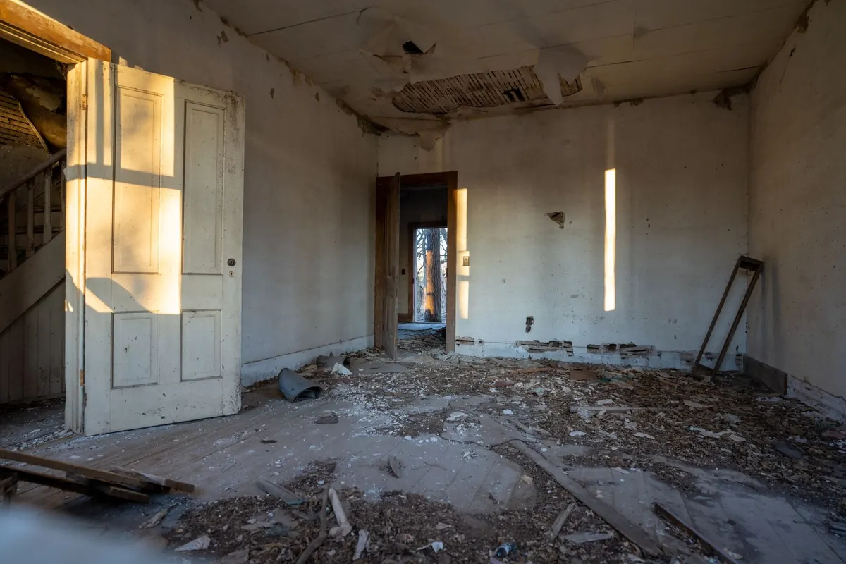 An empty, run-down interior of a vacant house where a squatter could move in