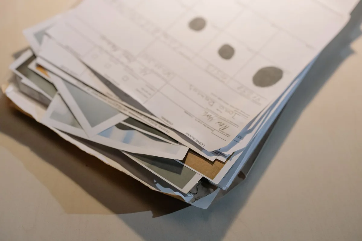 A stack of legal property documents that can reveal a clouded title or title defect