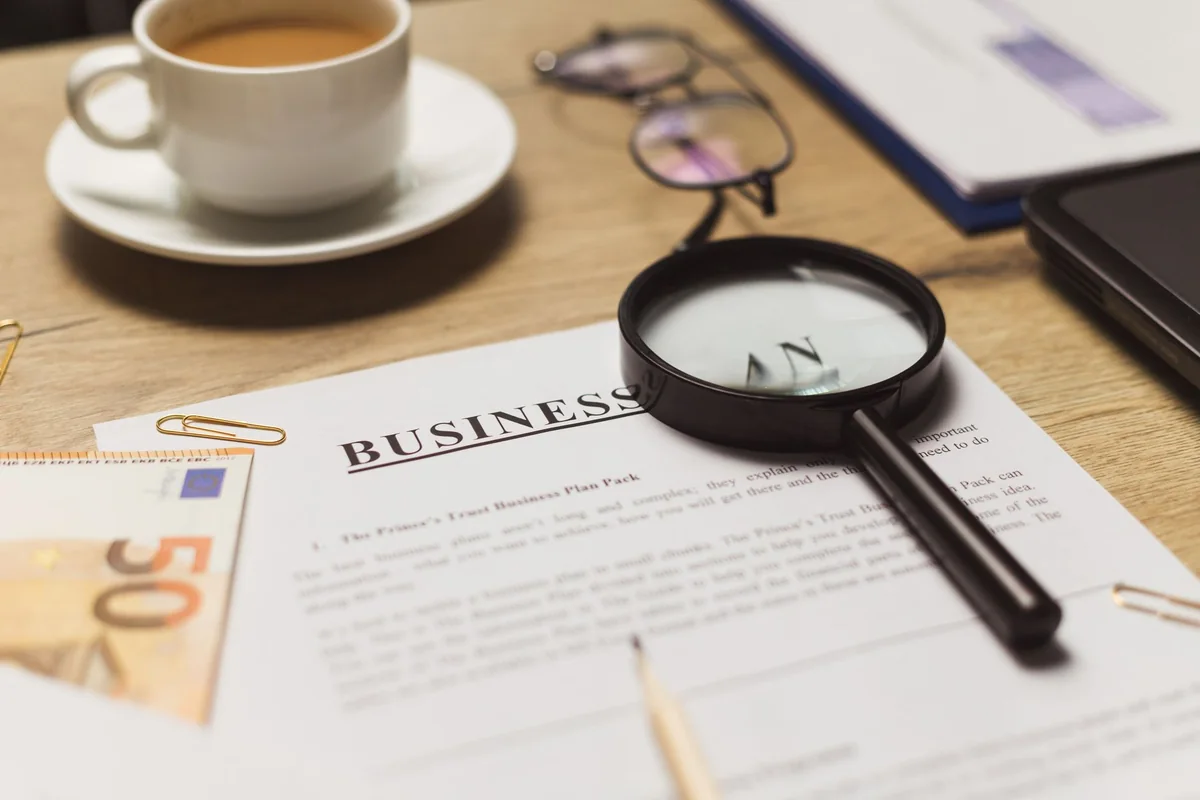 A magnifying glass over documents, examining common Iowa title defects