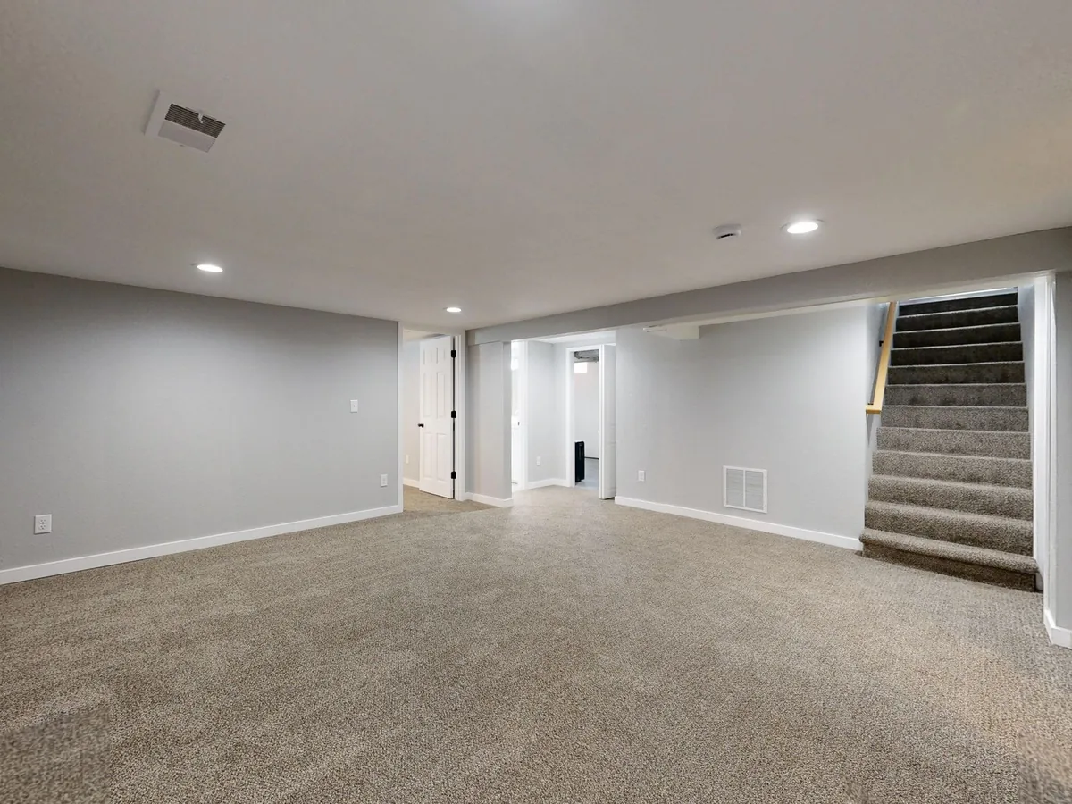 A finished basement living room, a common piece of unpermitted work in Iowa homes