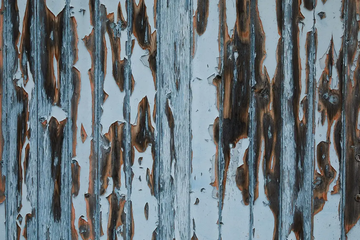 Peeling paint on an older wooden house exterior, a common FHA minimum property requirement flag on pre-1978 homes