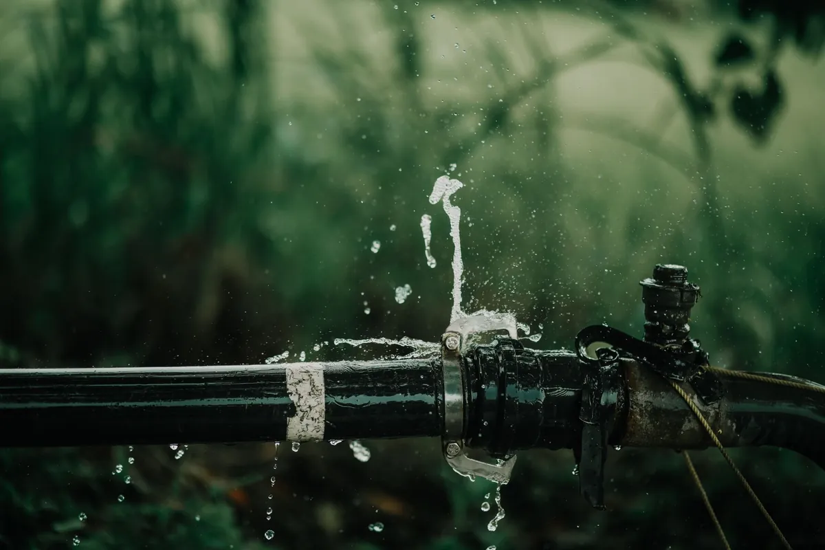 A leaking water pipe, the kind of repair that pushes a tired landlord toward selling a rental property in Iowa